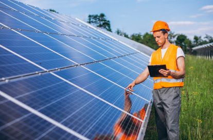 man-worker-firld-by-solar-panels